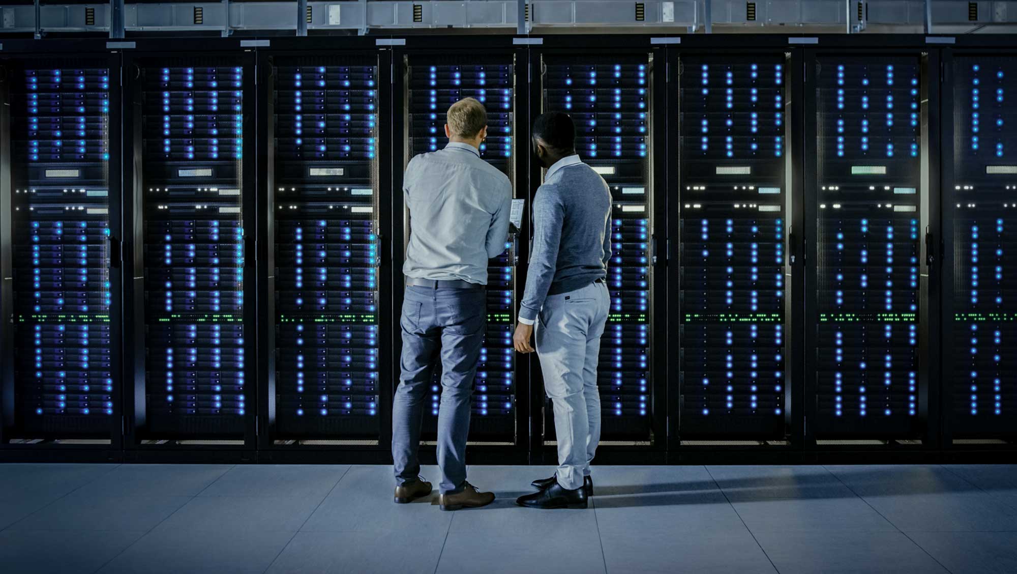 two man looking at a server rack
